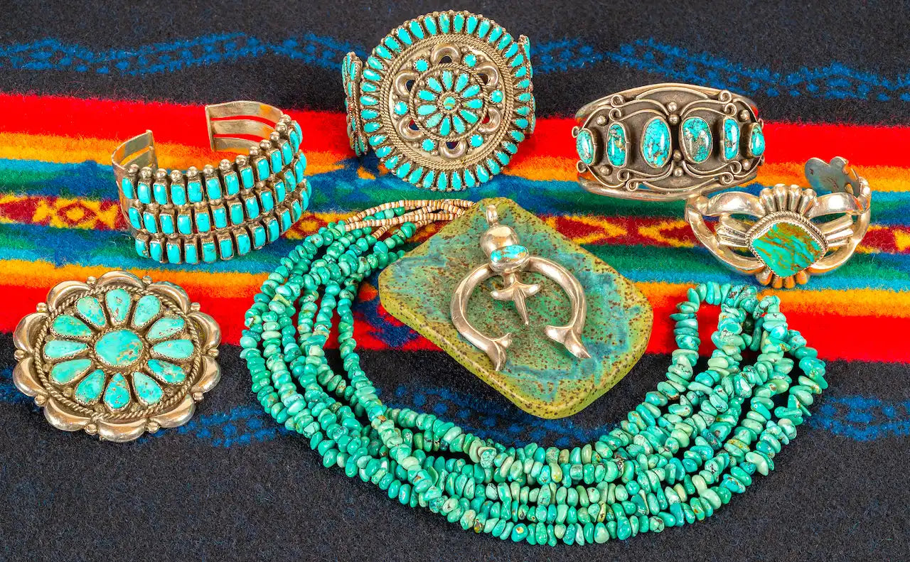 Collection of Native American turquoise and silver jewelry including bracelets, necklaces, and a belt buckle with a Kokopelli design.