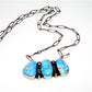 Navajo Golden Hills turquoise necklace featuring three blue turquoise stones on silver chain from The Southwestern Style Gallery