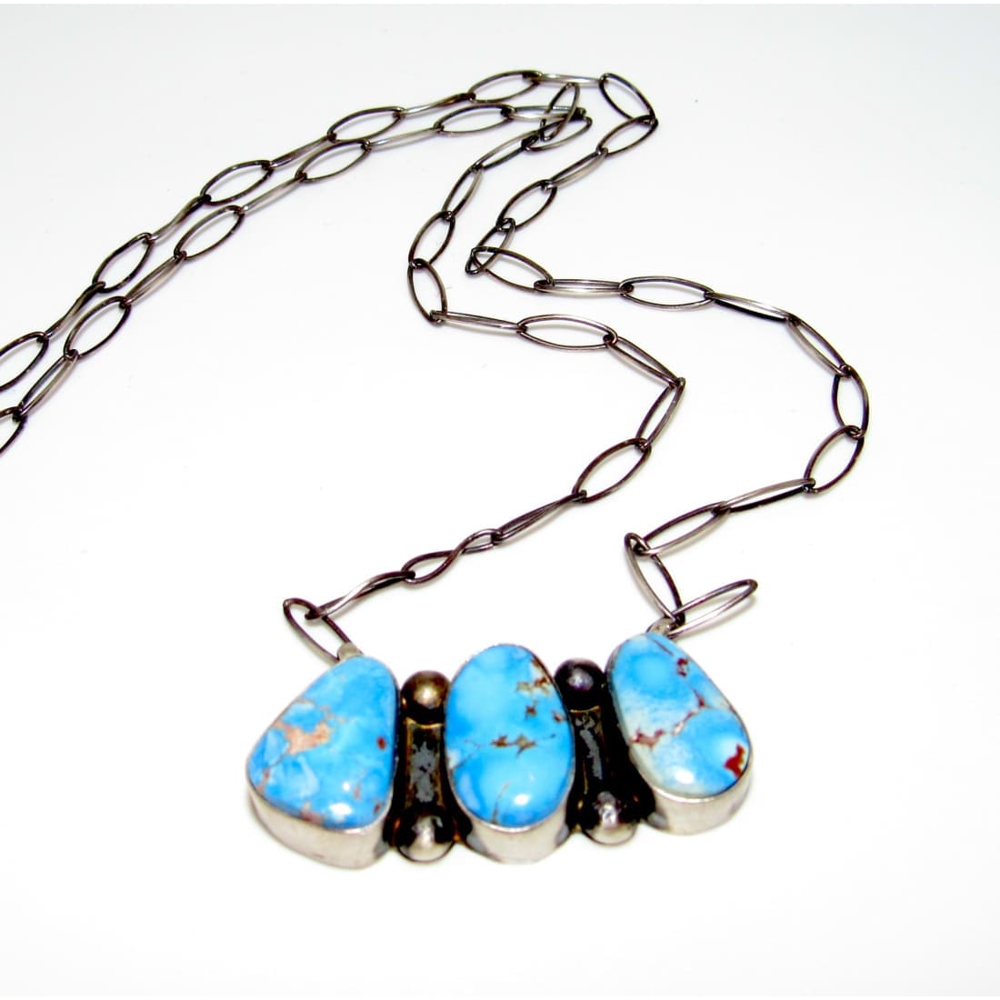 Navajo Golden Hills turquoise necklace featuring three blue turquoise stones on silver chain from The Southwestern Style Gallery