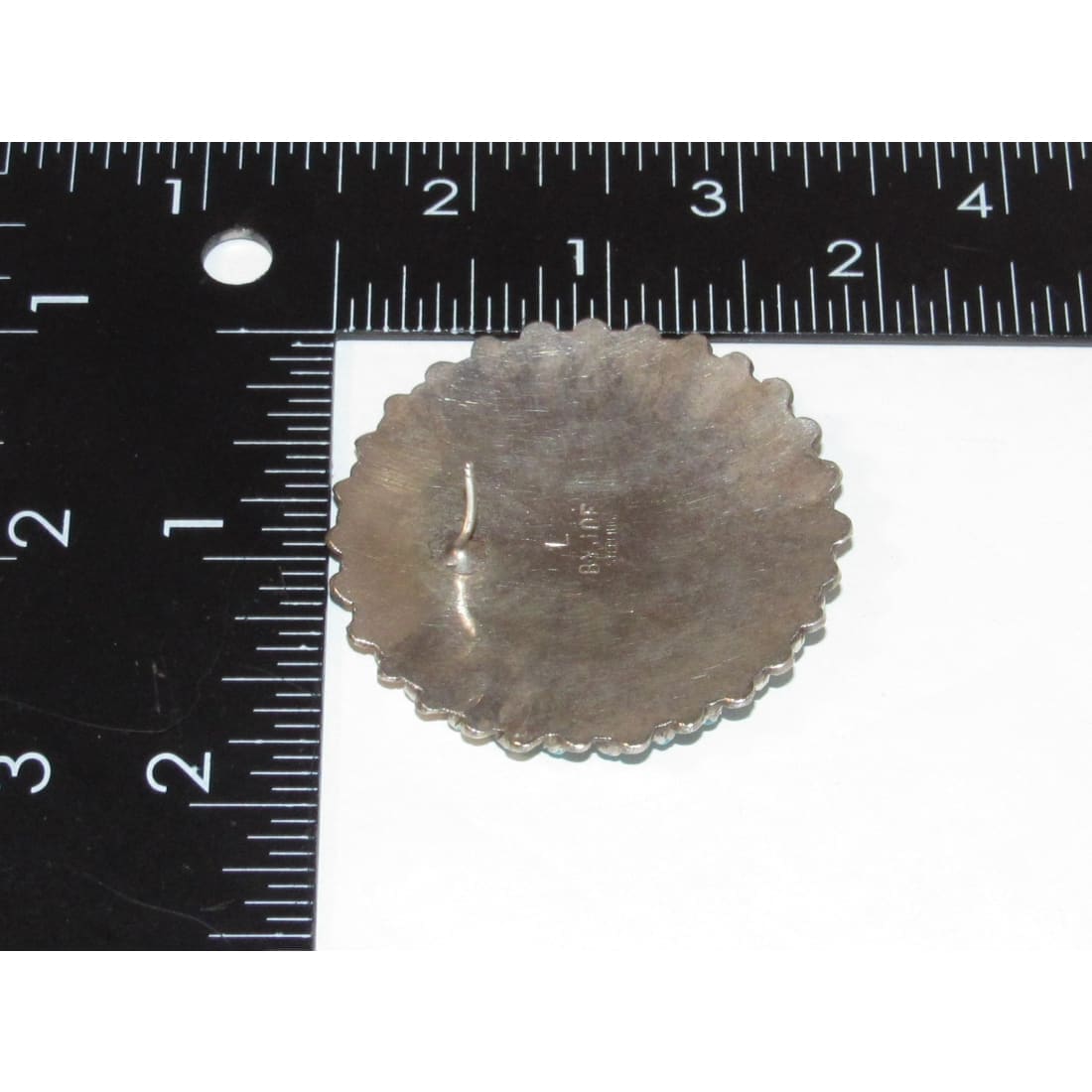 Back view of Zuni petit point turquoise earrings showing silver scalloped edge and hook clasp